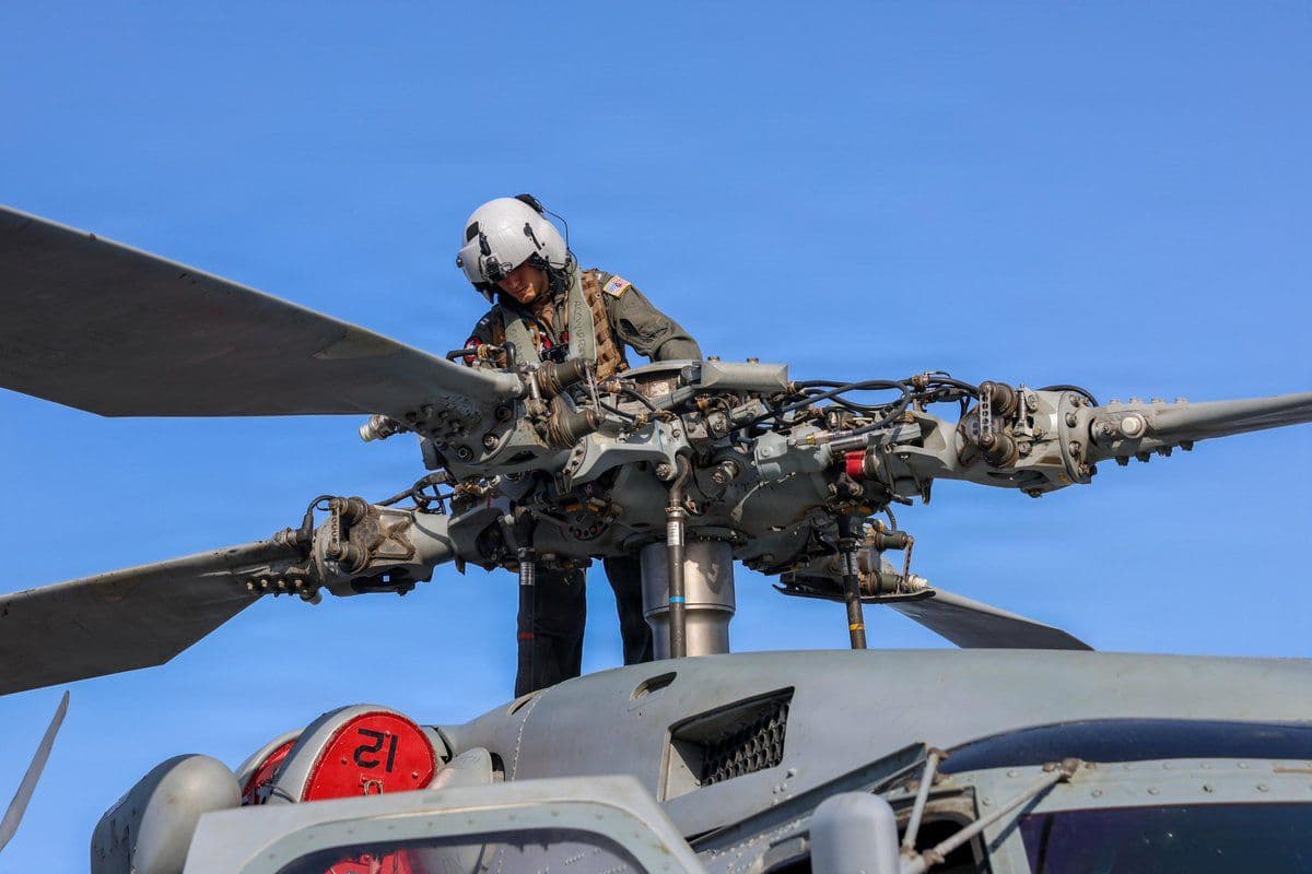 @U.S. Central Command: A U.S. Sailor conducts preflight checks on an MH-60R Sea Hawk helicopter aboard USS John Finn (DDG 113). Multiple ships and helicopters are currently enforcing the U.S. blockade against Iranian ports.