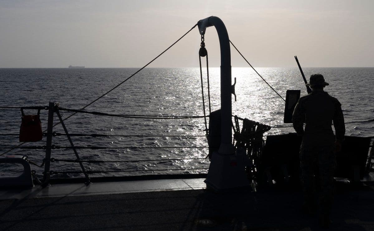 @U.S. Central Command: A U.S. Sailor watches a commercial ship as U.S. forces continue to enforce a blockade against Iranian ports, preventing ships from entering or exiting. American forces have directed 38 ships to turn a